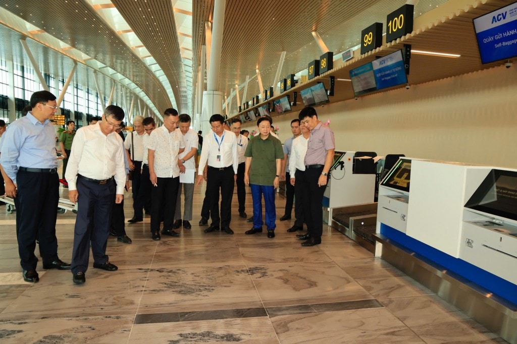 Phó Thủ tướng nghe báo cáo về tiến độ hoàn thiện hạng mục đá lát nền nhà ga T3 - Ảnh: VGP/Minh Khôi