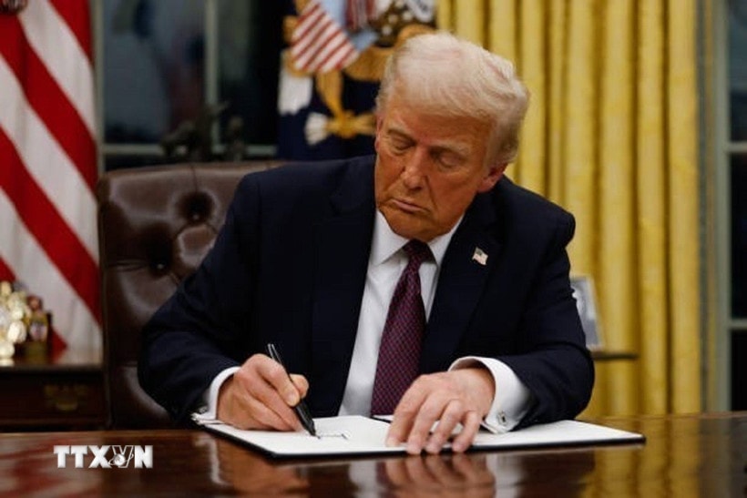 Tổng thống Mỹ Donald Trump ký sắc lệnh tại Nhà Trắng. (Ảnh: Getty Images/TTXVN)