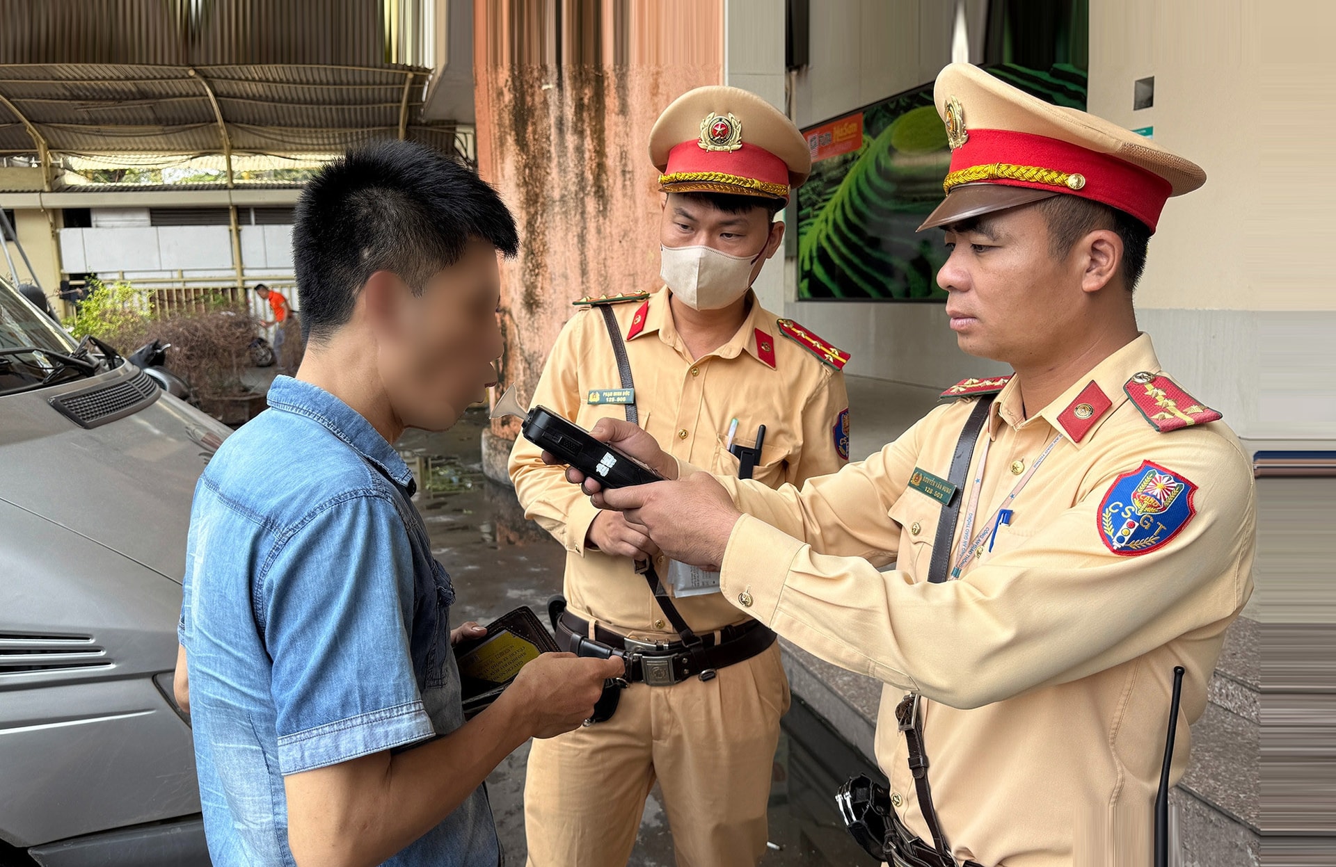 ប៉ូលិសចរាចរណ៍ក្រុងហាណូយពិនិត្យសីតុណ្ហភាពអ្នកបើកបររថយន្តក្រុង មុនពេលចាកចេញពីស្ថានីយ៍រថយន្តក្រុងនៅ My Dinh Phuong Tu Liem។-Anh Dinh Hieu.jpg