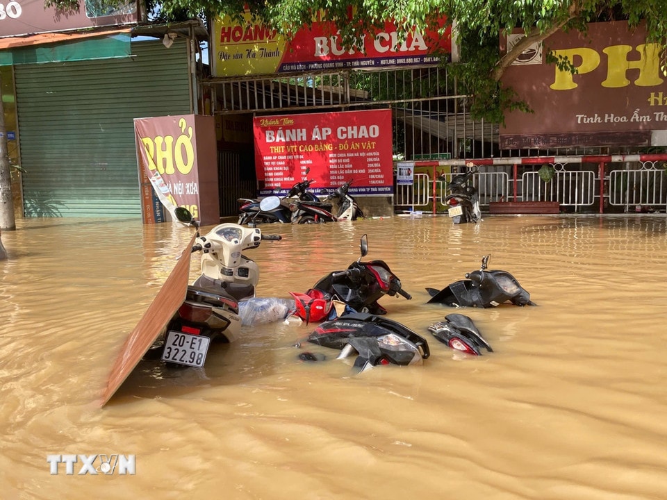 Xe máy đổ la liệt ngập sâu trong nước tại phường Quan Triều, tỉnh Thái Nguyên. (Ảnh: Thắng Trung/TTXVN)