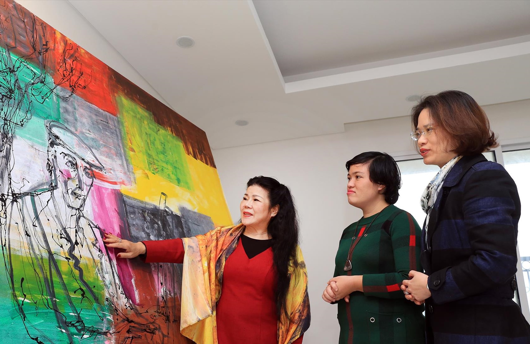 Artist Van Duong Thanh introduces a work. Anh Thanh Giang.jpg