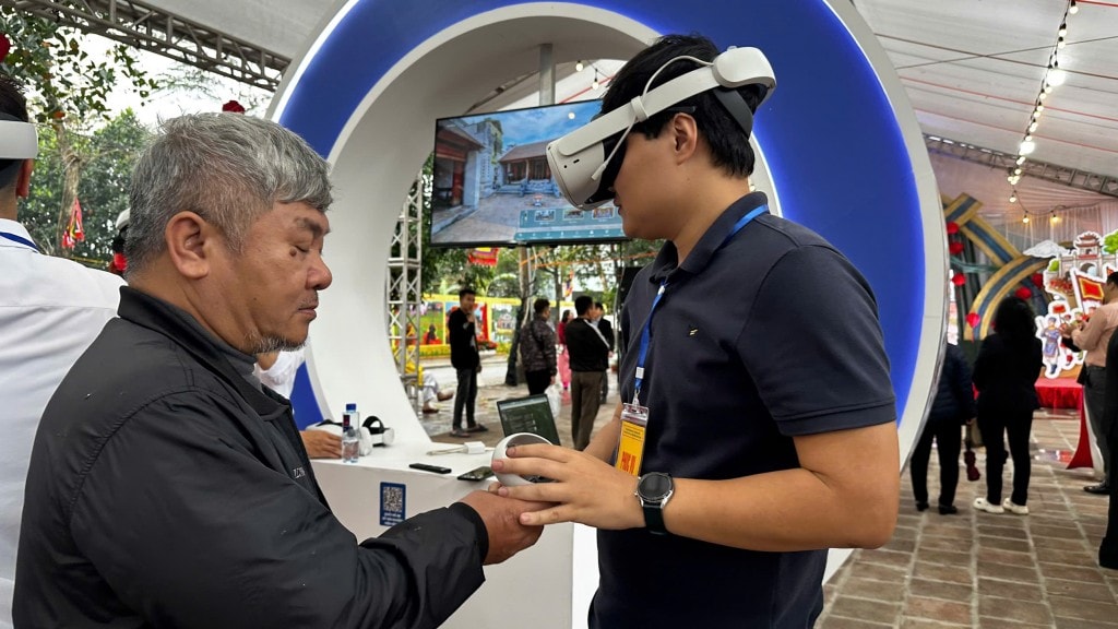Tại booth VR Giếng Ngọc, người dân đeo kính thực tế ảo để tham quan di tích Cổ Loa (Ảnh: Thái Sơn)