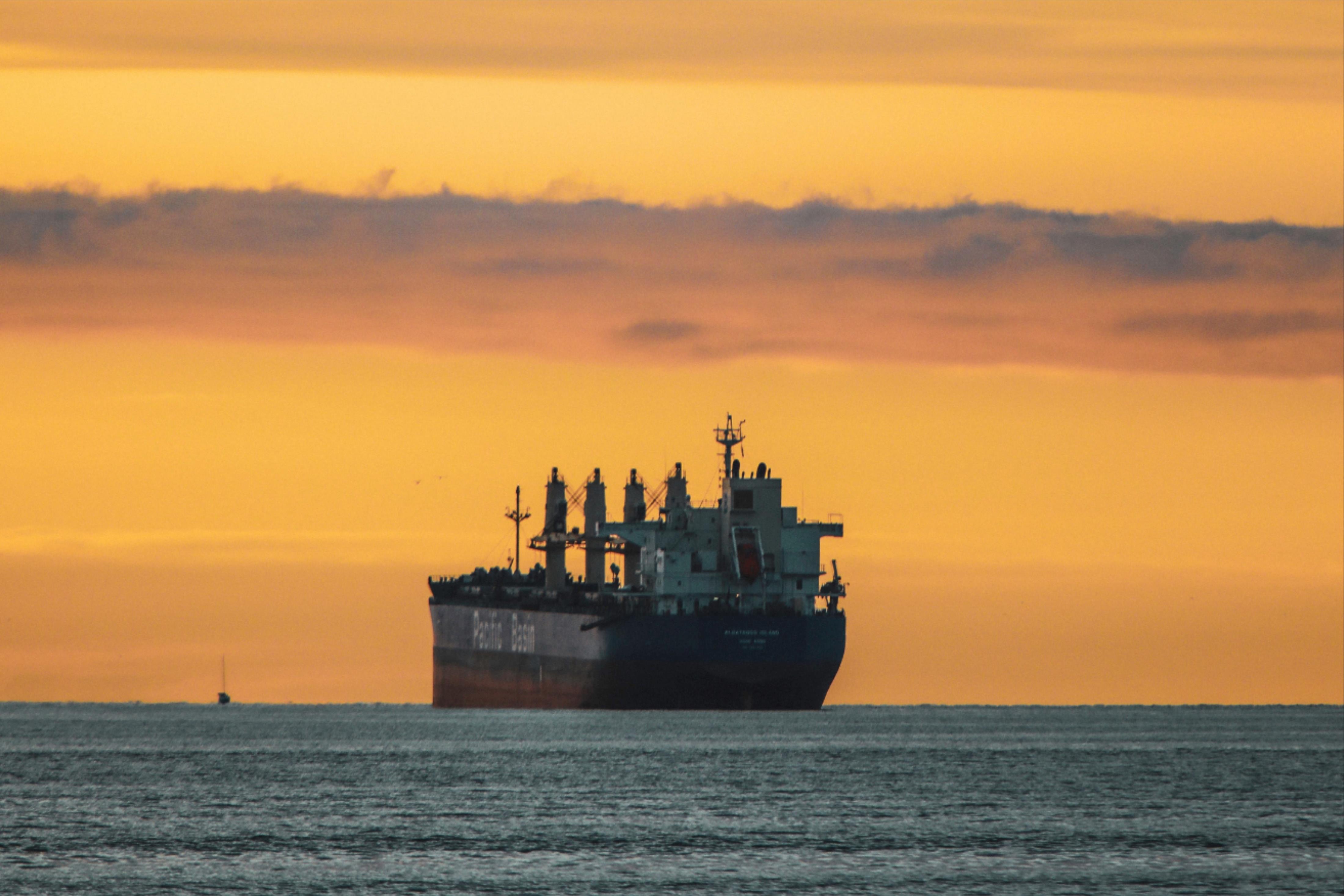 vertical-shot-old-ship-lake-colorful-sky-sunset.jpg