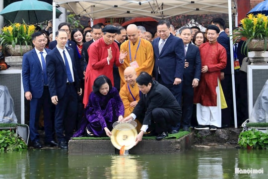 Chủ tịch nước Lương Cường và phu nhân thực hiện nghi thức thả cá chép ở hồ Hoàn Kiếm.